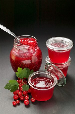 Raspberry jam, redcurrant jelly, redcurrants, leaves Stock Photo - Premium Royalty-Free, Code: 659-01859382