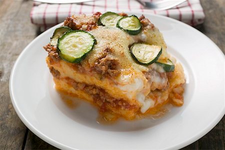 Portion of polenta bake with mince and courgettes Stock Photo - Premium Royalty-Free, Code: 659-01859496