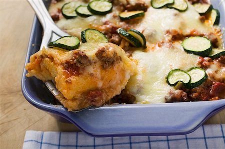 Polenta bake with mince and courgettes, portion on server Stock Photo - Premium Royalty-Free, Code: 659-01859492