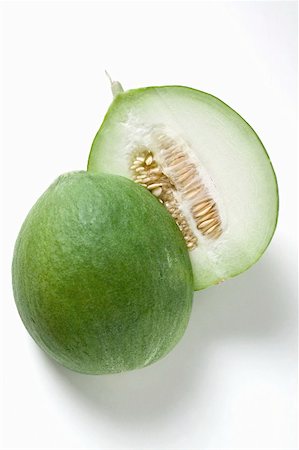 Green honeydew melon, halved Stock Photo - Premium Royalty-Free, Code: 659-01859507