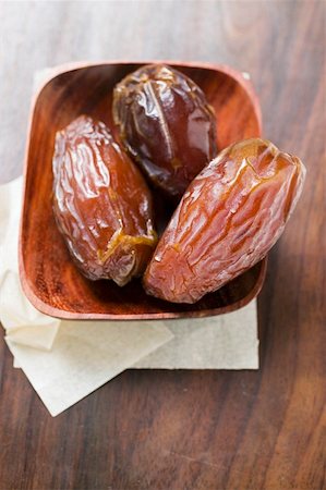 dates fruits - Three dried dates in wooden bowl Stock Photo - Premium Royalty-Free, Code: 659-01859513