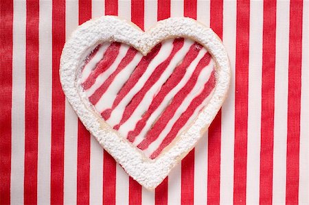 frosted cookies top view - Heart-shaped biscuit with red and white striped icing Stock Photo - Premium Royalty-Free, Code: 659-01859565