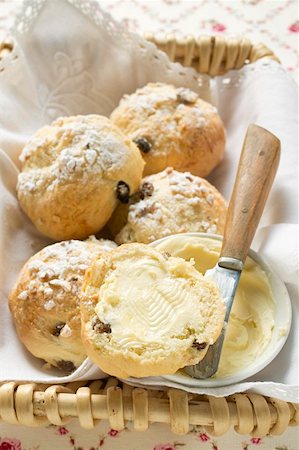 spreading butter on bread - Sugared fruit scones with butter in bread basket Stock Photo - Premium Royalty-Free, Code: 659-01859580
