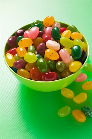 fruit jelly - Coloured jelly beans in and beside green bowl Stock Photo - Premium Royalty-Free, Code: 659-01859610