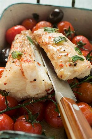 Monkfish with cherry tomatoes and olives in roasting tin Stock Photo - Premium Royalty-Free, Code: 659-01859861