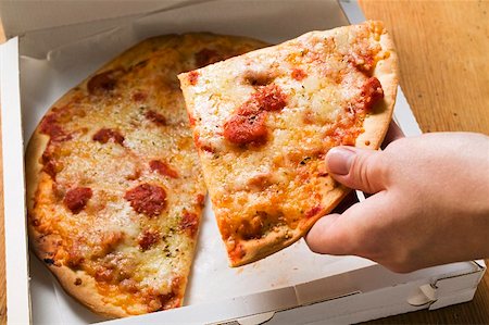 simsearch:659-03529071,k - Hand taking a slice of pizza Margherita out of pizza box Foto de stock - Sin royalties Premium, Código: 659-01859929