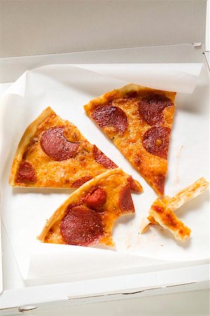 Three slices of pepperoni pizza in pizza box Stock Photo - Premium Royalty-Free, Code: 659-01859921