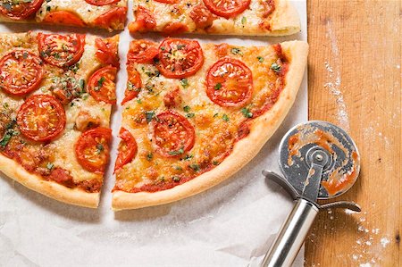 recipes paper - Cheese and tomato pizza with oregano (quartered) Stock Photo - Premium Royalty-Free, Code: 659-01859960