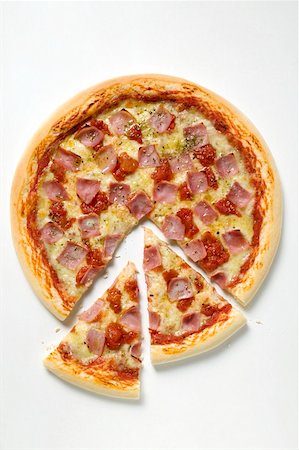 pizza top view - Ham, cheese and tomato pizza (partly sliced) Stock Photo - Premium Royalty-Free, Code: 659-01859972