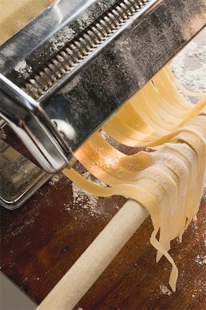 Tagliatelle coming out of pasta maker Stock Photo - Premium Royalty-Free, Code: 659-01850098