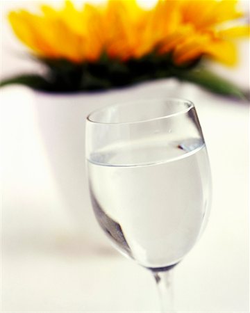 simsearch:659-06152108,k - A glass of water in front of a flower Foto de stock - Sin royalties Premium, Código: 659-01850122