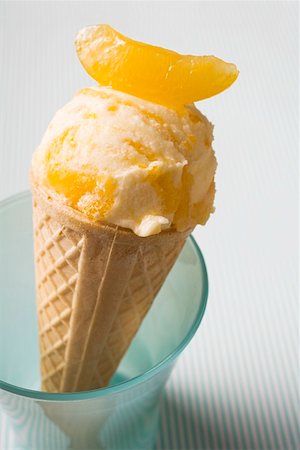 Orange ice cream in wafer cone in a beaker Stock Photo - Premium Royalty-Free, Code: 659-01850226