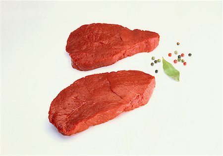 steak chunk - Two beef steaks, peppercorns, bay leaf Stock Photo - Premium Royalty-Free, Code: 659-01850556