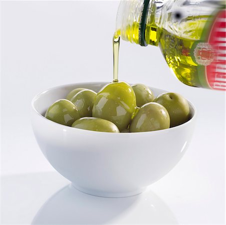 Pouring olive oil over olives Stock Photo - Premium Royalty-Free, Code: 659-01851133