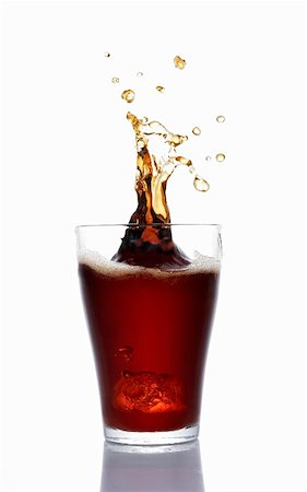 Cola splashing out of a glass Stock Photo - Premium Royalty-Free, Code: 659-01851471