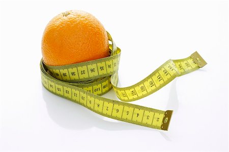 An orange with a tape measure Stock Photo - Premium Royalty-Free, Code: 659-01851486