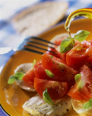 simsearch:659-03528079,k - Sprinkling insalata caprese with olive oil Stock Photo - Premium Royalty-Free, Code: 659-01851683