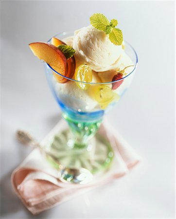 sundaes ice cream images - Vanilla ice cream with fruit & lemon balm in a sundae glass Stock Photo - Premium Royalty-Free, Code: 659-01851696