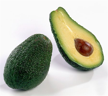 One whole avocado beside an avocado half Stock Photo - Premium Royalty-Free, Code: 659-01851844
