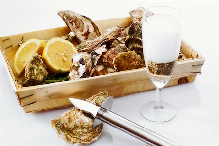 raw oyster - Fresh oysters in a box with a glass of champagne Stock Photo - Premium Royalty-Free, Code: 659-01852091