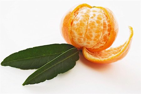 Partly peeled clementine with two leaves Stock Photo - Premium Royalty-Free, Code: 659-01852321