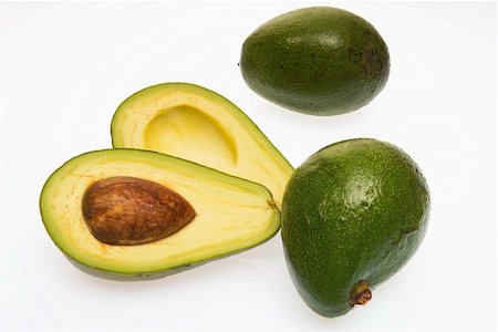 Three avocados, one halved Stock Photo - Premium Royalty-Free, Code: 659-01852364