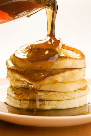 pancake breakfast - Pouring maple syrup over pancakes (2) Stock Photo - Premium Royalty-Free, Code: 659-01852488