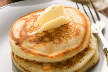 Pfannkuchen mit Klecks Butter auf einen Teller Stockbilder - Premium RF Lizenzfrei, Bildnummer: 659-01852492
