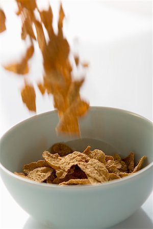 Cereal flakes falling into a cereal bowl Stock Photo - Premium Royalty-Free, Code: 659-01852638