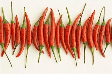 peperoncini - Red chili peppers lying in a row Stock Photo - Premium Royalty-Free, Code: 659-01852735