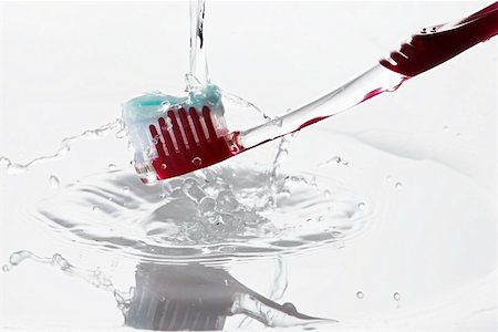 A toothbrush under running water Stock Photo - Premium Royalty-Free, Code: 659-01853007