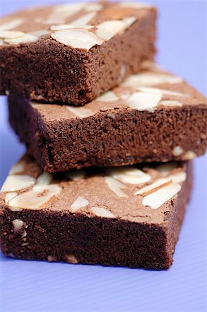 Three brownies with almonds in a pile Stock Photo - Premium Royalty-Free, Code: 659-01853065