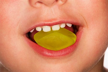 eat mouth closeup - Child eating yellow wine gum Stock Photo - Premium Royalty-Free, Code: 659-01853121