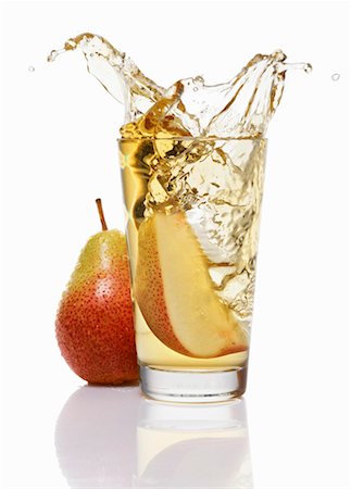 simsearch:659-03537021,k - Wedge of pear falling into a glass of pear juice Stock Photo - Premium Royalty-Free, Code: 659-01853182