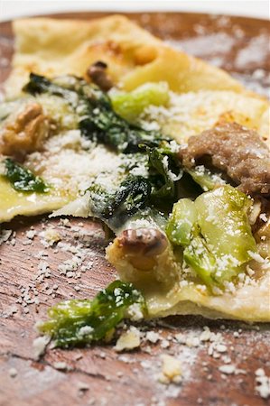 Remains of flatbread with mince, chard and Parmesan Stock Photo - Premium Royalty-Free, Code: 659-01853464