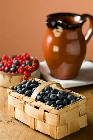 Blueberries in a basket and small bowl of mixed berries Stock Photo - Premium Royalty-Free, Code: 659-01853838