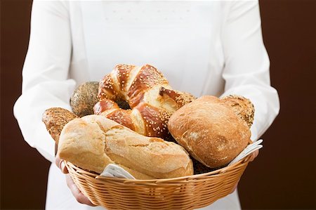 different bread rolls - Chambermaid serving assorted bread rolls in bread basket Stock Photo - Premium Royalty-Free, Code: 659-01864012