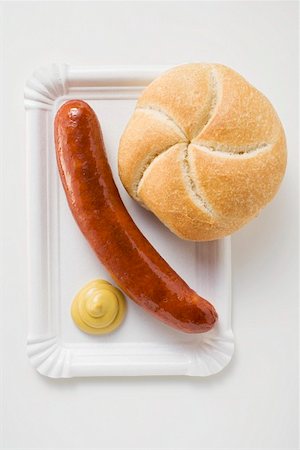 Sausage (bratwurst) with mustard & bread roll on paper plate Stock Photo - Premium Royalty-Free, Code: 659-01864046