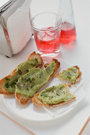 Bruschetta with avocado spread on plate, Campari Soda Stock Photo - Premium Royalty-Free, Code: 659-01864093