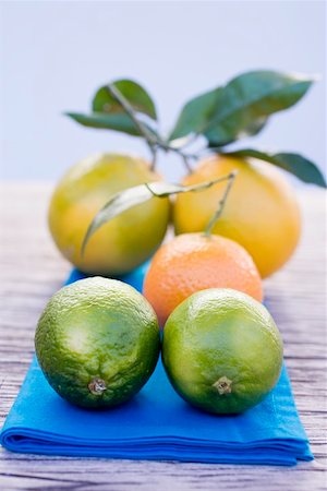 Oranges, clementine and limes on blue cloth Stock Photo - Premium Royalty-Free, Code: 659-01864127