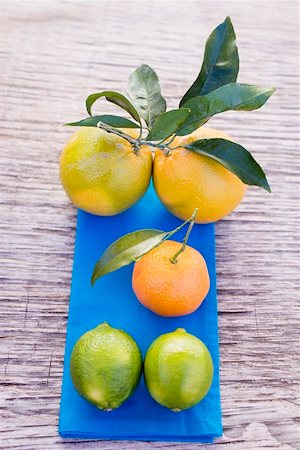 Oranges, clementine & limes on blue cloth (overhead view) Stock Photo - Premium Royalty-Free, Code: 659-01864128
