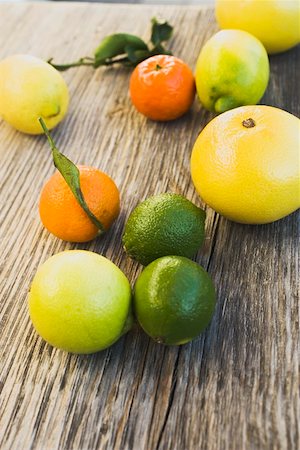 Assorted citrus fruit on wooden background Stock Photo - Premium Royalty-Free, Code: 659-01864162