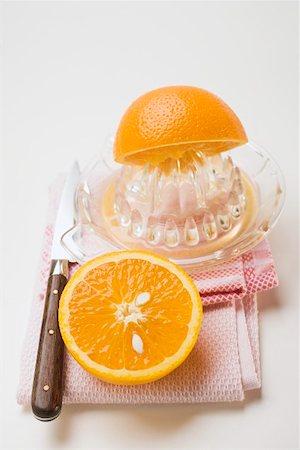 squeezer - Squeezing an orange Foto de stock - Sin royalties Premium, Código: 659-01864222