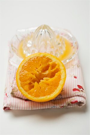 simsearch:659-01855164,k - Half an orange in front of citrus squeezer Stock Photo - Premium Royalty-Free, Code: 659-01864230