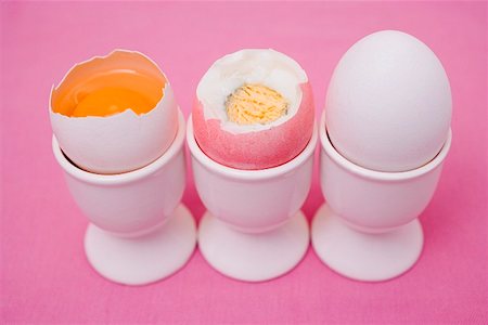 simsearch:659-01850865,k - Three eggs in eggcups (raw & boiled with top cut off, whole) Stock Photo - Premium Royalty-Free, Code: 659-01864323