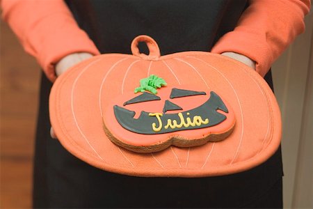 Hands holding Halloween biscuit with name on pot holder Stock Photo - Premium Royalty-Free, Code: 659-01864406