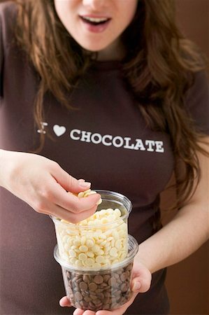 simsearch:659-03522828,k - Woman eating chocolate chips Stock Photo - Premium Royalty-Free, Code: 659-01864458