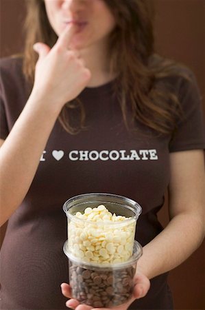 simsearch:659-03522828,k - Woman eating chocolate chips Stock Photo - Premium Royalty-Free, Code: 659-01864459