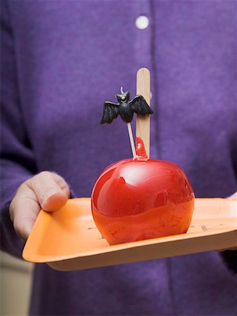 Woman holding tray of toffee apples for Halloween Stock Photo - Premium Royalty-Free, Code: 659-01864582