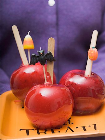 Woman holding tray of toffee apples for Halloween Stock Photo - Premium Royalty-Free, Code: 659-01864583